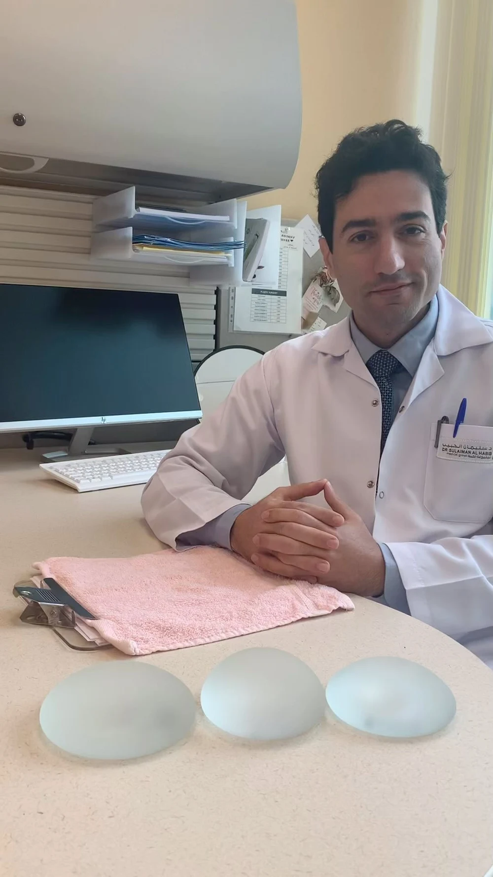 Dr Haber explaining breast augmentation with silicone implant models